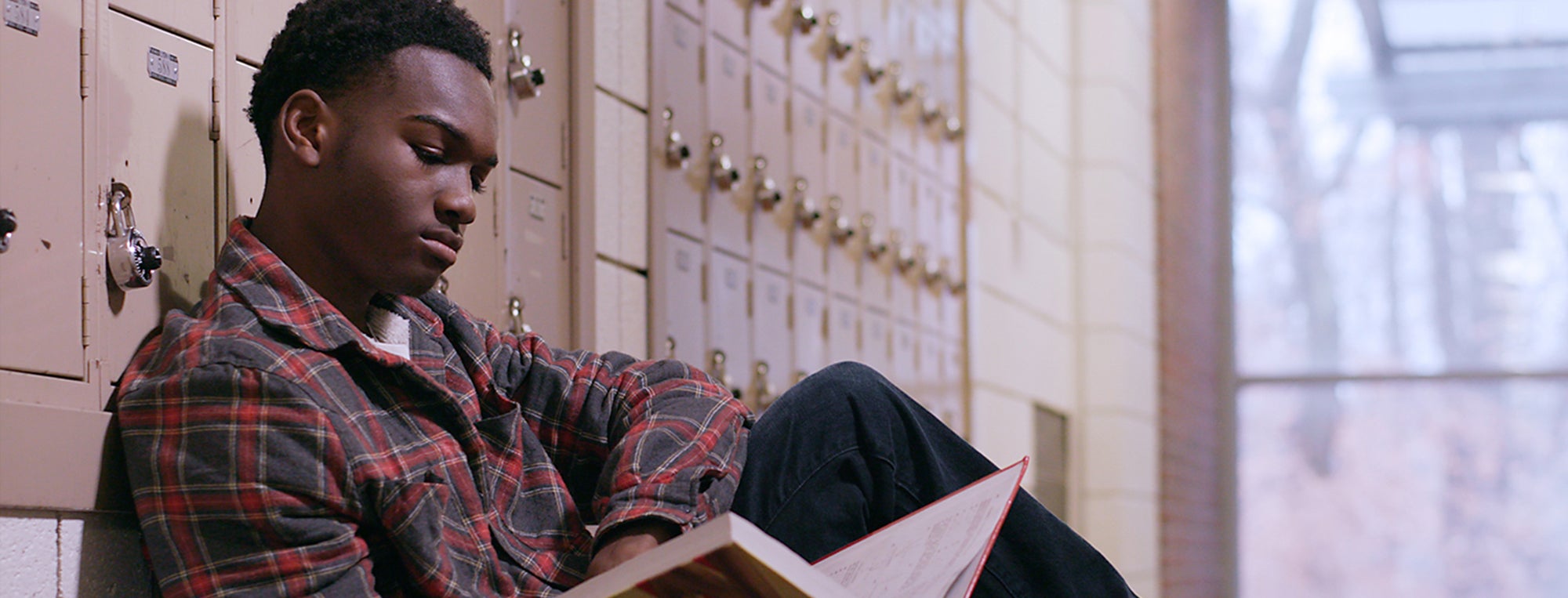 Photo of high school student by locker