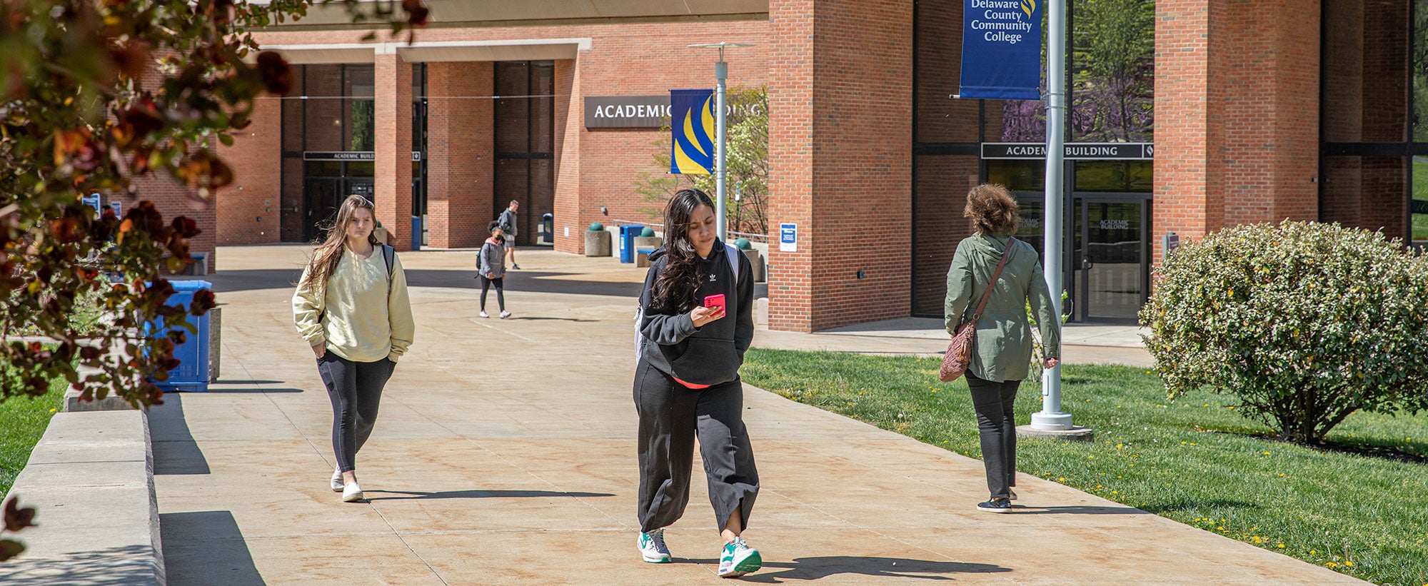 Students walking on campus in spring