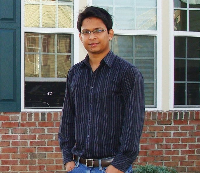 Aerik standing in front of a house.