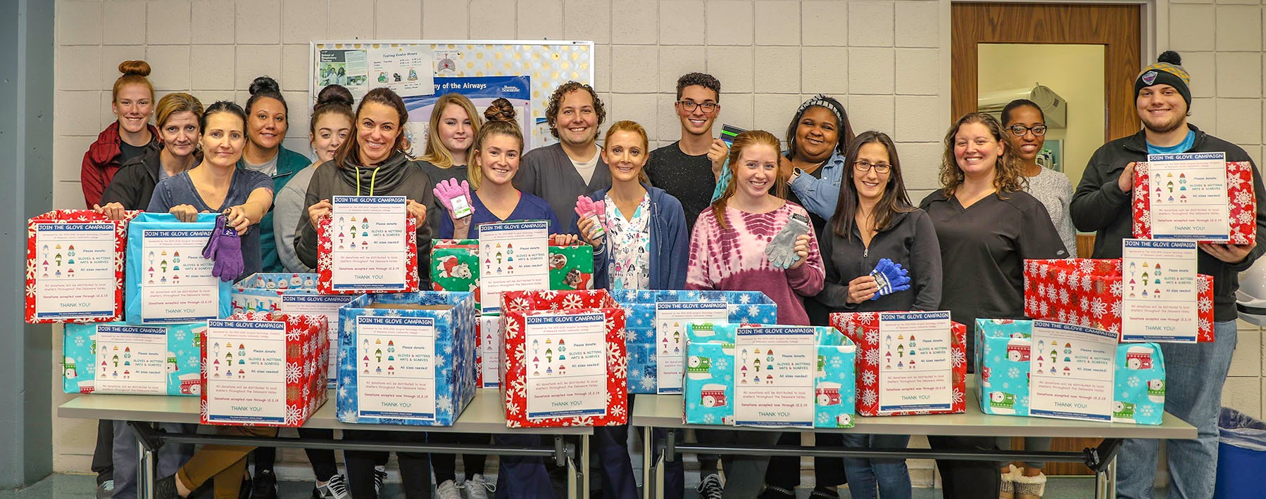 Photo of students with collection boxes for gLOVE campaign