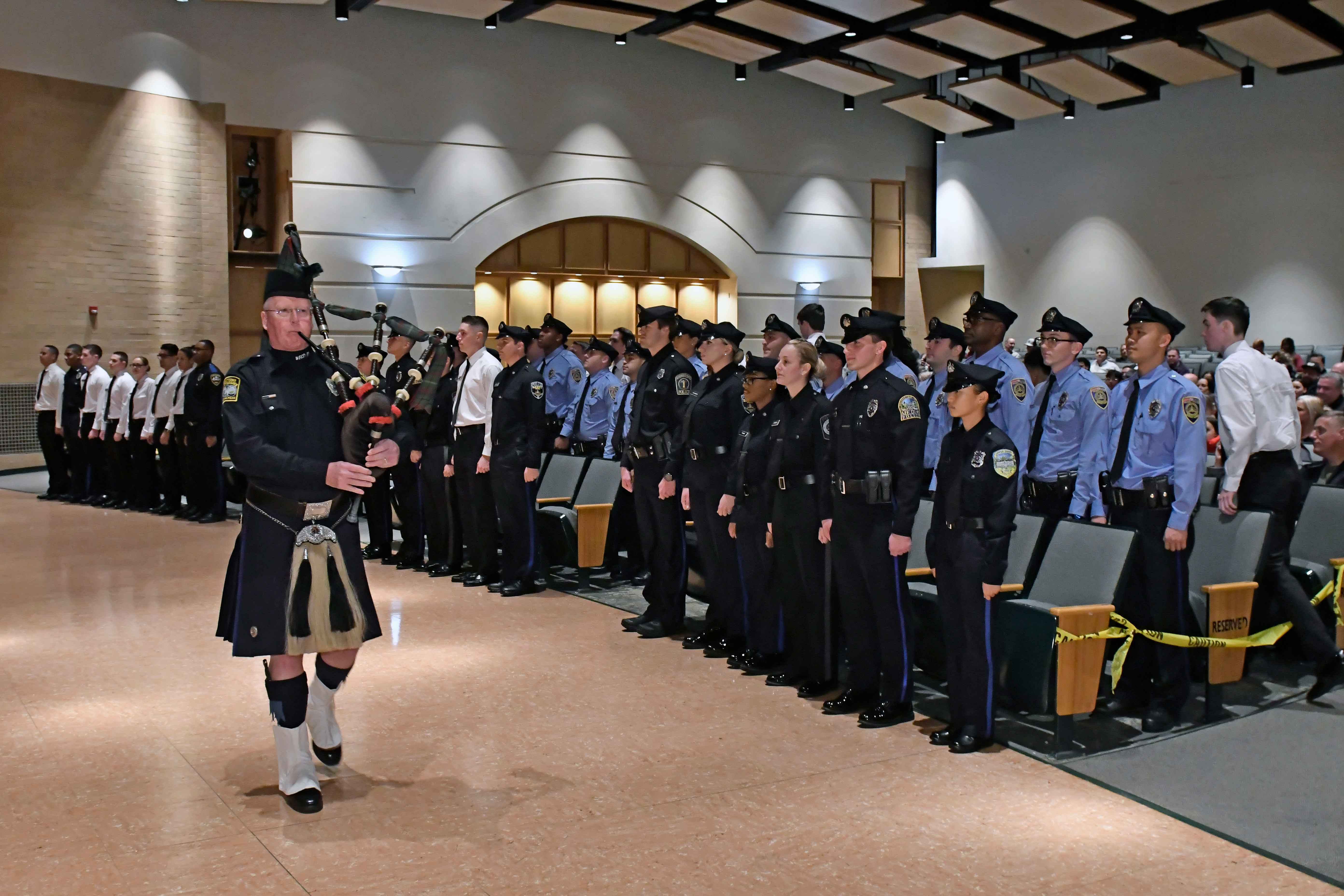 December 2023 MPA Graduation Bagpiper and graduates