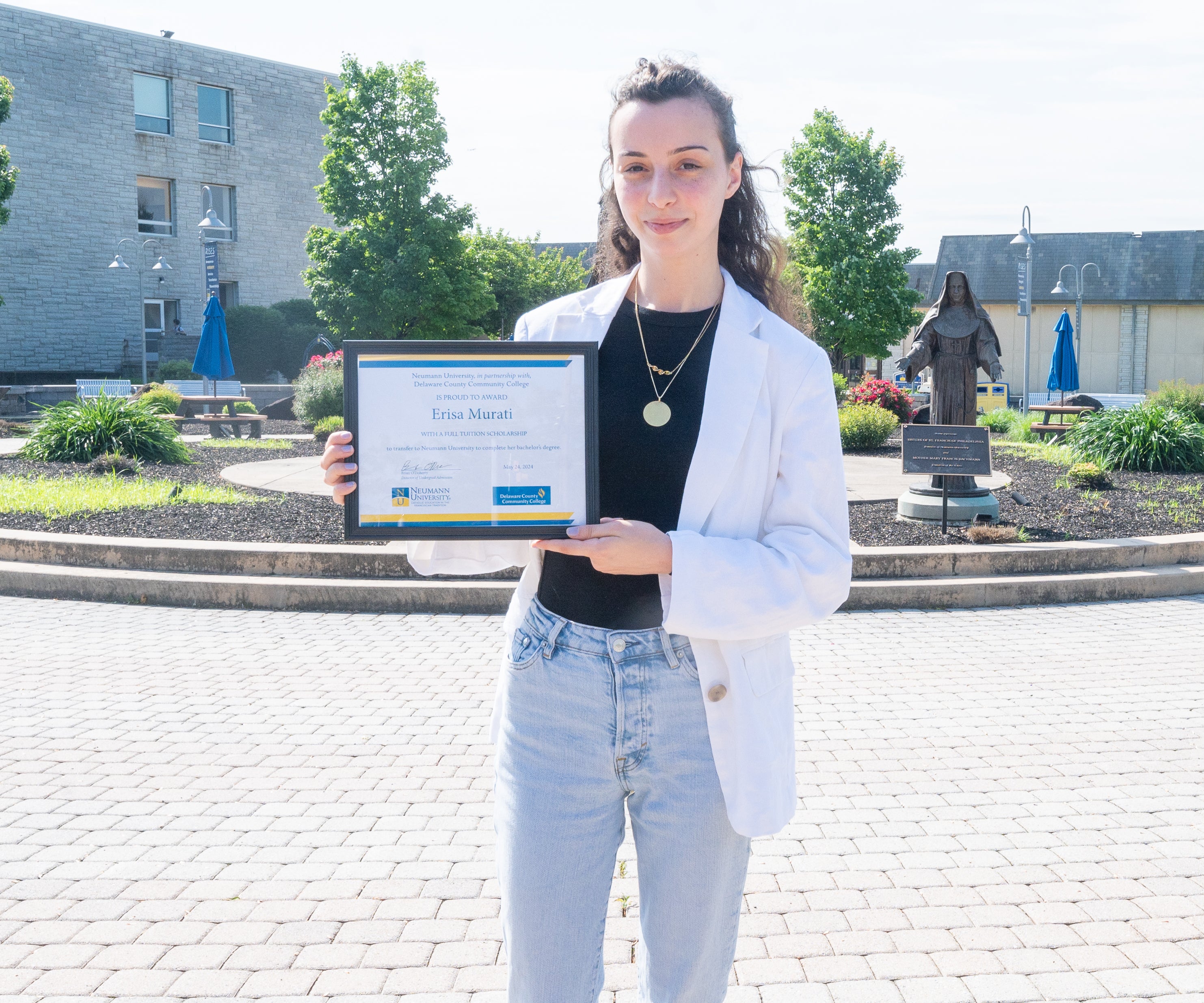 Erisa Murati holding her certificate of transfer