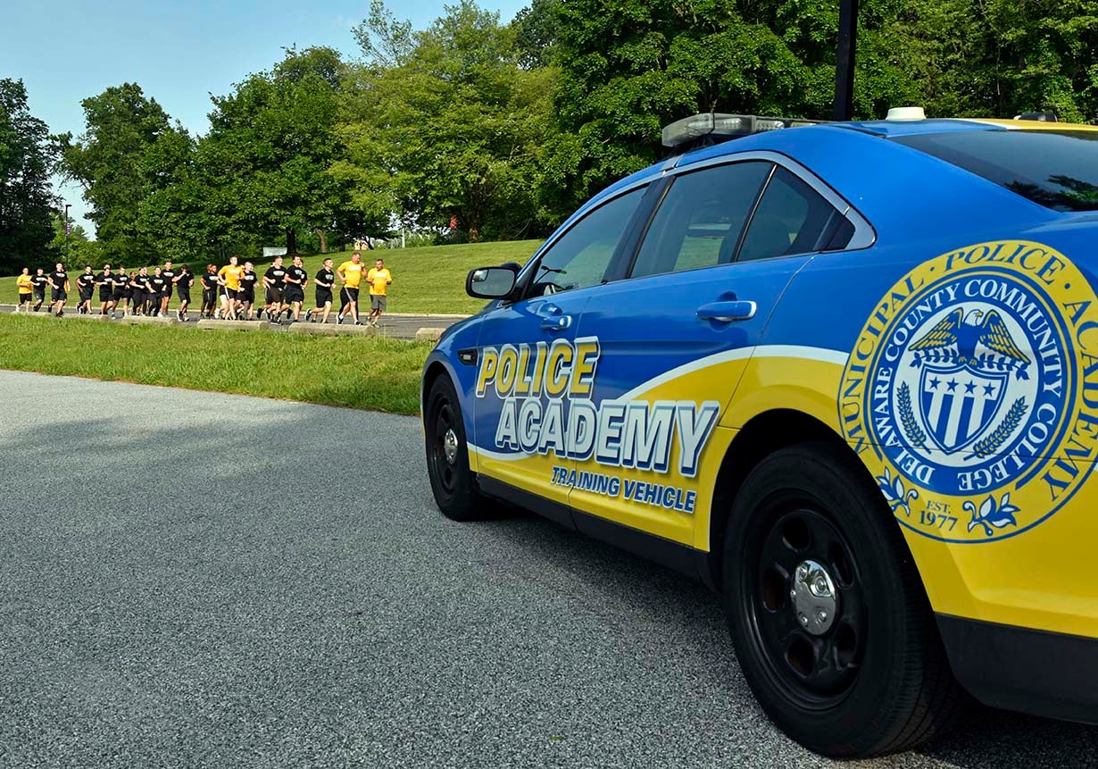 Municipal Police Academy (MPA) cadets prepare for their last run with the MPA’s training vehicle in the foreground