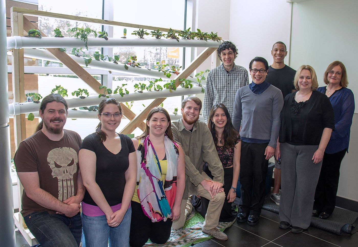 Group photo in front of garden