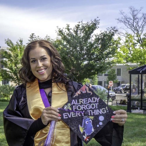 Grad posing with decorated cap