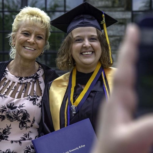 Graduate poses for a photo