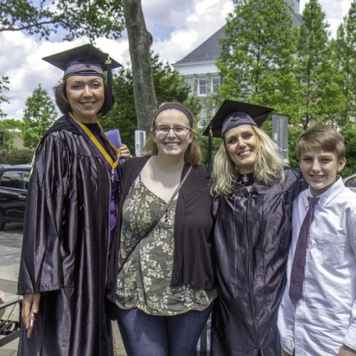 Group photo with two graduates and family