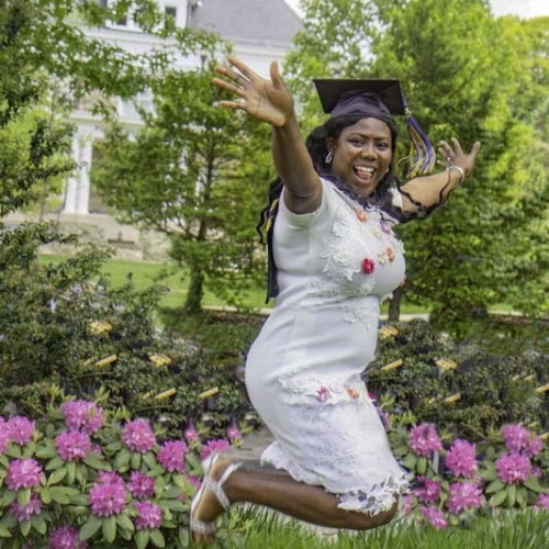 Graduate jumping in the air